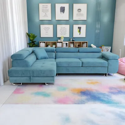 A light blue sectional sofa is shown in a room with blue walls and a colorful rug.