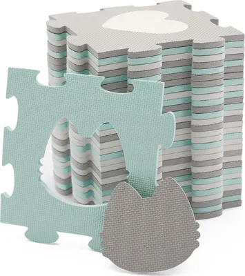 A stack of interlocking foam puzzle mats with a heart shape cut out of the top mat, and a cat-shaped piece in the foreground.
