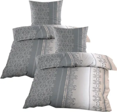 A stack of bedding items, including pillows and a duvet cover, arranged on a white background.