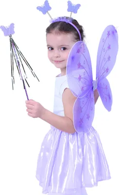 A young girl wearing a fairy costume with butterfly wings, a headband, and a wand.