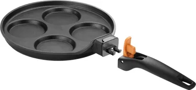 A black frying pan with four circular indentations for eggs, with a detachable orange and black handle shown separately.