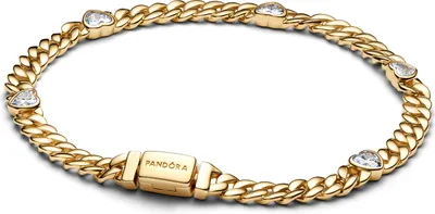 A close-up studio shot of a gold-colored Pandora bracelet with heart-shaped cubic zirconia stones.