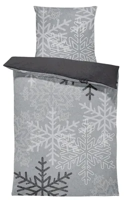 A folded duvet cover and pillowcase set with a snowflake pattern.