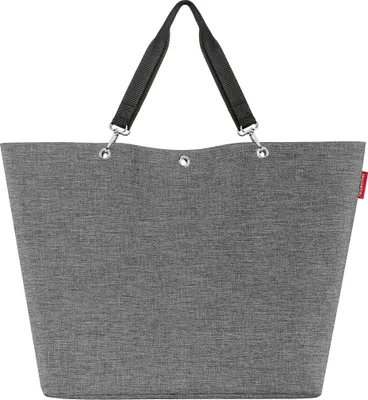 A studio shot of a gray shopper bag with black handles.
