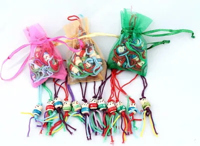 Produktbild von 07, Glückspüppchen 12 er Set, Holzpuppe Mini im Organzabeutel