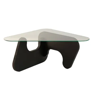 A modern coffee table with a glass top and a dark, sculptural base.