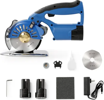 A collection of items for a fabric cutter, including the cutter itself, batteries, charger, and spare parts.