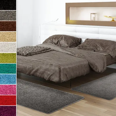 A bedroom scene with a bed and rugs.