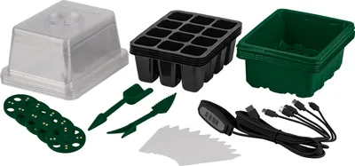 A collection of items for starting seeds, including trays, a dome, and small tools.