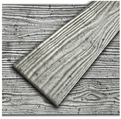A close-up view of a decorative foam panel with a concrete look, laid diagonally over a background of similar panels.