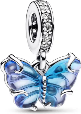 A close-up studio shot of a blue Murano glass butterfly charm with silver accents.