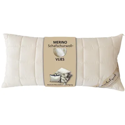 A cream-colored pillow with a product tag attached.