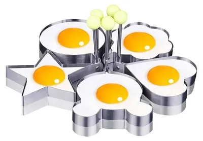Five stainless steel egg molds in different shapes, each containing a fried egg.