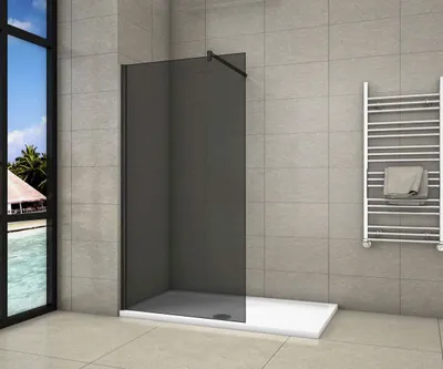 A modern bathroom with a walk-in shower, towel rack, and a large window overlooking a tropical scene.