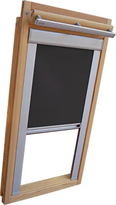 A close-up view of a dark gray blackout roller blind installed in a wooden skylight frame.