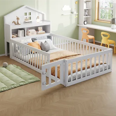 A child's bed with protective railings and a headboard shaped like a house, set in a room with a desk and chairs.