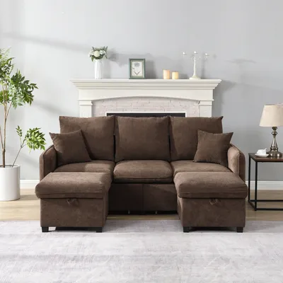 A brown sectional sofa with two storage ottomans in a living room with a fireplace.