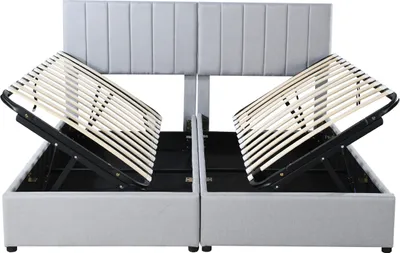 A grey upholstered bed frame with the mattress support slats lifted to reveal storage space underneath.
