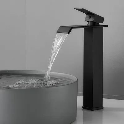 A black waterfall faucet is shown in use, with water flowing into a grey basin.