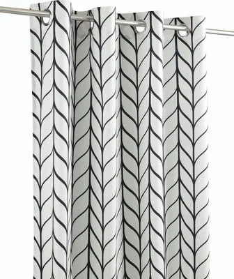 A close-up view of several black and white patterned curtains hanging from a rod.