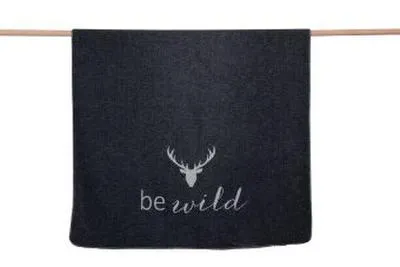 A dark grey blanket with a deer silhouette and the text 'be wild' is hanging on a wooden rod against a white background.