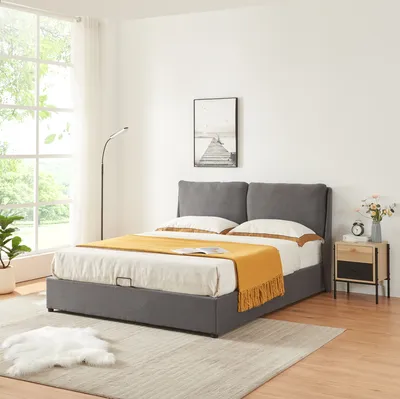 A bedroom scene with a bed, nightstand, and floor lamp.