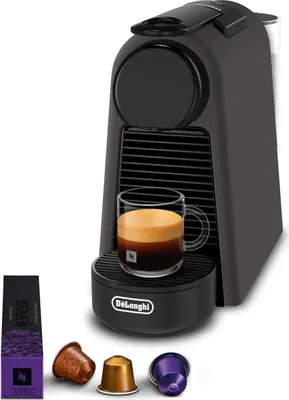 A De'Longhi Nespresso Essenza Mini coffee machine with a cup of espresso and coffee capsules.