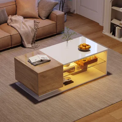 A modern living room scene featuring a coffee table with integrated lighting and storage, placed on a rug in front of a leather sofa.