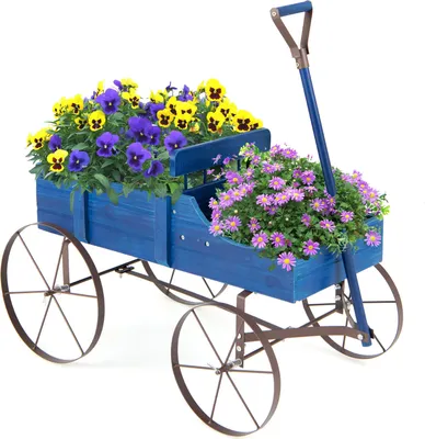 A blue wooden wagon filled with yellow and purple pansies and pink asters, set against a white background.