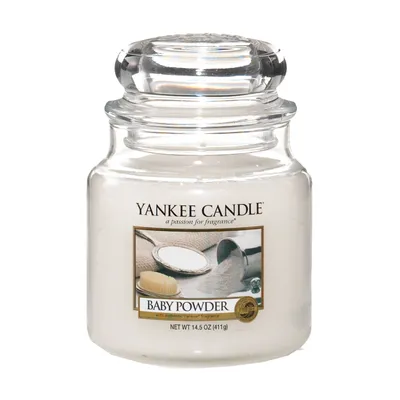 A Yankee Candle "Baby Powder" scented candle in a clear glass jar with a clear glass lid.