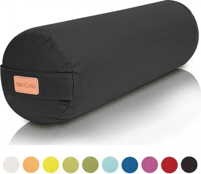 A black yoga bolster is shown on a white background with a reflection.