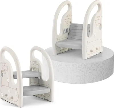 Two views of a beige and gray baby step stool, one with two steps and one with a seat, displayed against a white background with a textured gray circular platform.