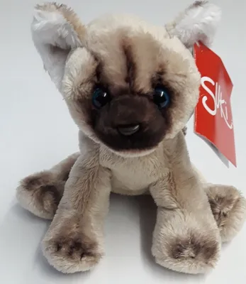 A plush toy cat sitting on a white surface.
