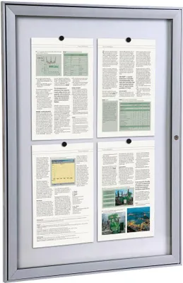 A bulletin board with four documents displayed inside a silver frame.