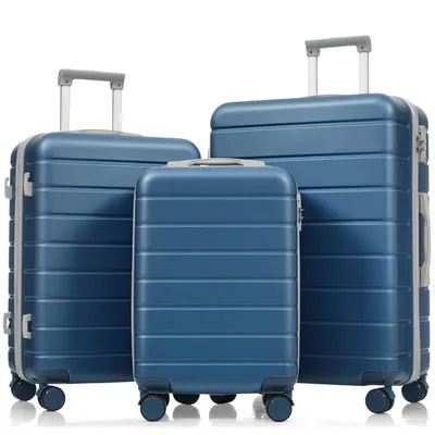 Three blue suitcases of different sizes are arranged in front of a white background.