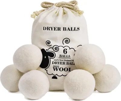 A bag of wool dryer balls with several balls in front of it.