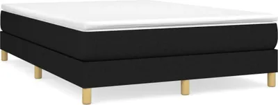 A black boxspring bed frame with a white mattress topper and wooden legs, shown against a white background.