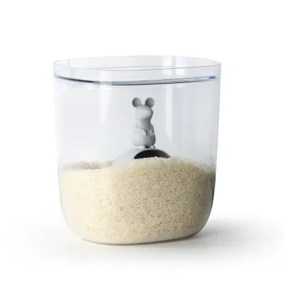 A clear, well-lit studio shot of a transparent storage container filled with rice, featuring a small gray mouse figurine on a scoop inside.