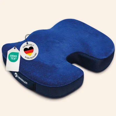 A blue orthopedic memory foam seat cushion is shown from a slightly elevated side angle on a light gray background.