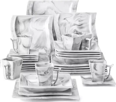 A collection of dinnerware with a marble-like pattern.