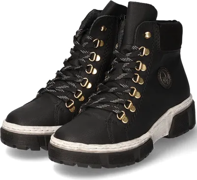 A pair of black lace-up boots with gold eyelets and a white sole, shown from a slightly angled front view.