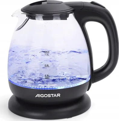 A glass electric kettle filled with water and illuminated by blue LED lights, sitting on its black base.