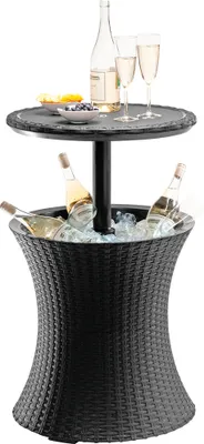A black rattan cooler table with a slate top, holding bottles of wine and champagne glasses.