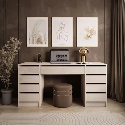 A modern home office setup with a desk, laptop, lamp, and artwork.