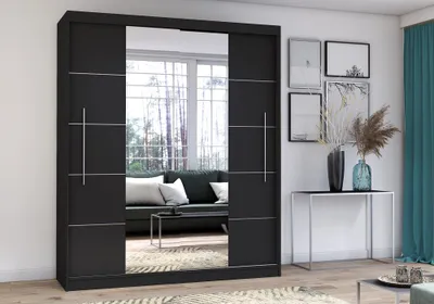 A modern bedroom or living room with a large black sliding door wardrobe with mirrored doors.