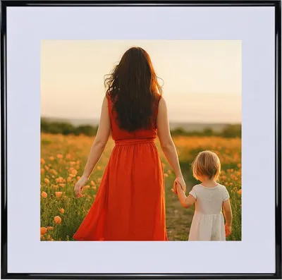 A woman and a child walking through a field of flowers at sunset.