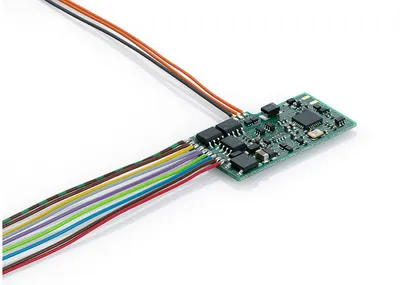 A close-up shot of a green circuit board with multiple wires attached, set against a white background.