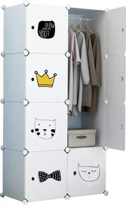 A modular white wardrobe with cartoonish designs on the doors, displaying clothes inside.