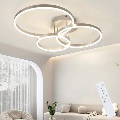A modern living room with a ceiling light fixture and furniture.