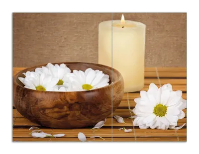Produktbild von Wallario Herdabdeckplatte aus Glas, Größe 70 x 52 cm 2-teilig, Motiv Stillleben - Kerzen und Blumenblüten in Holzschale